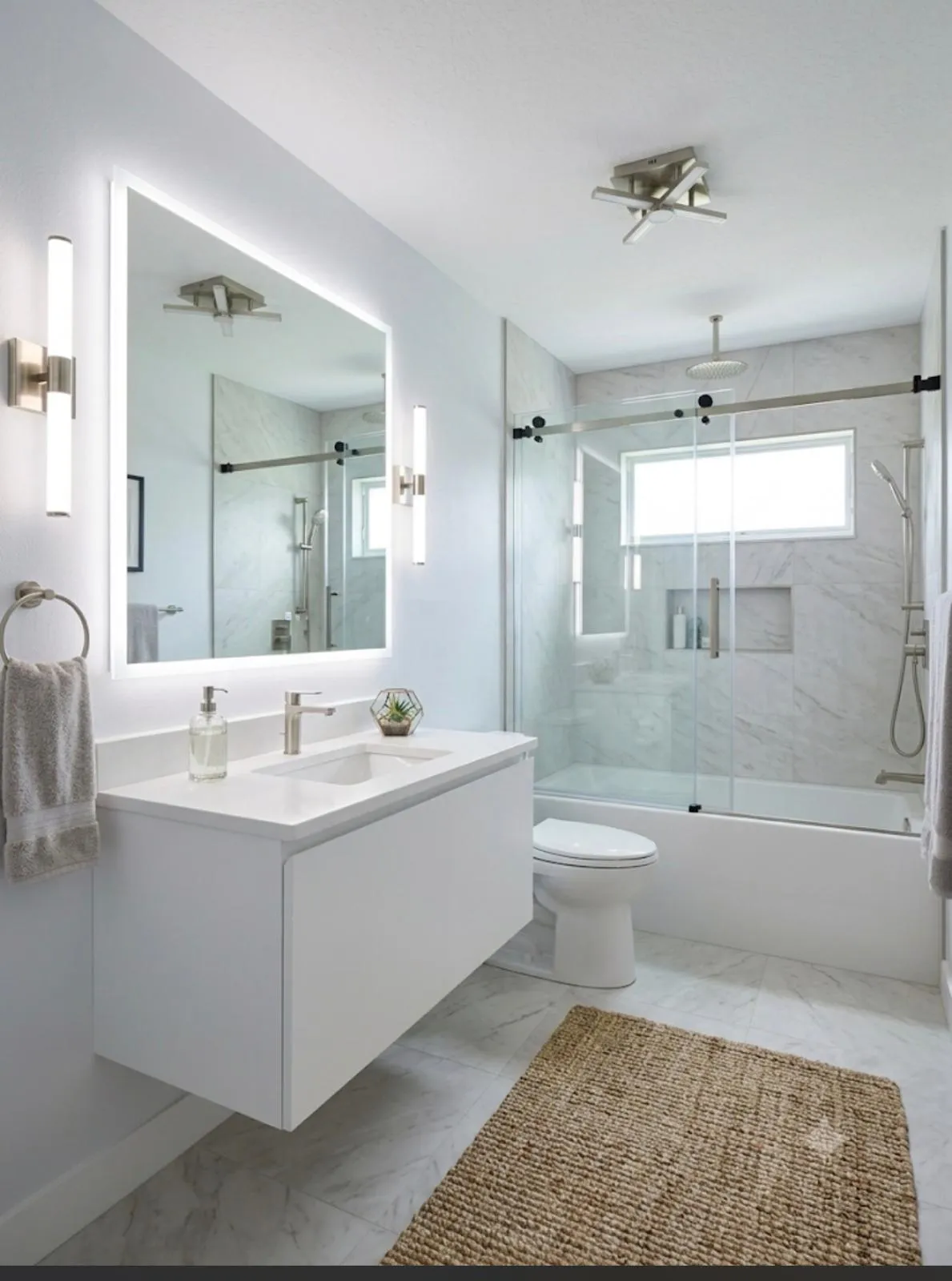 Floating white vanity with a glass sliding shower door, bathroom remodel in Port St Lucie, FL