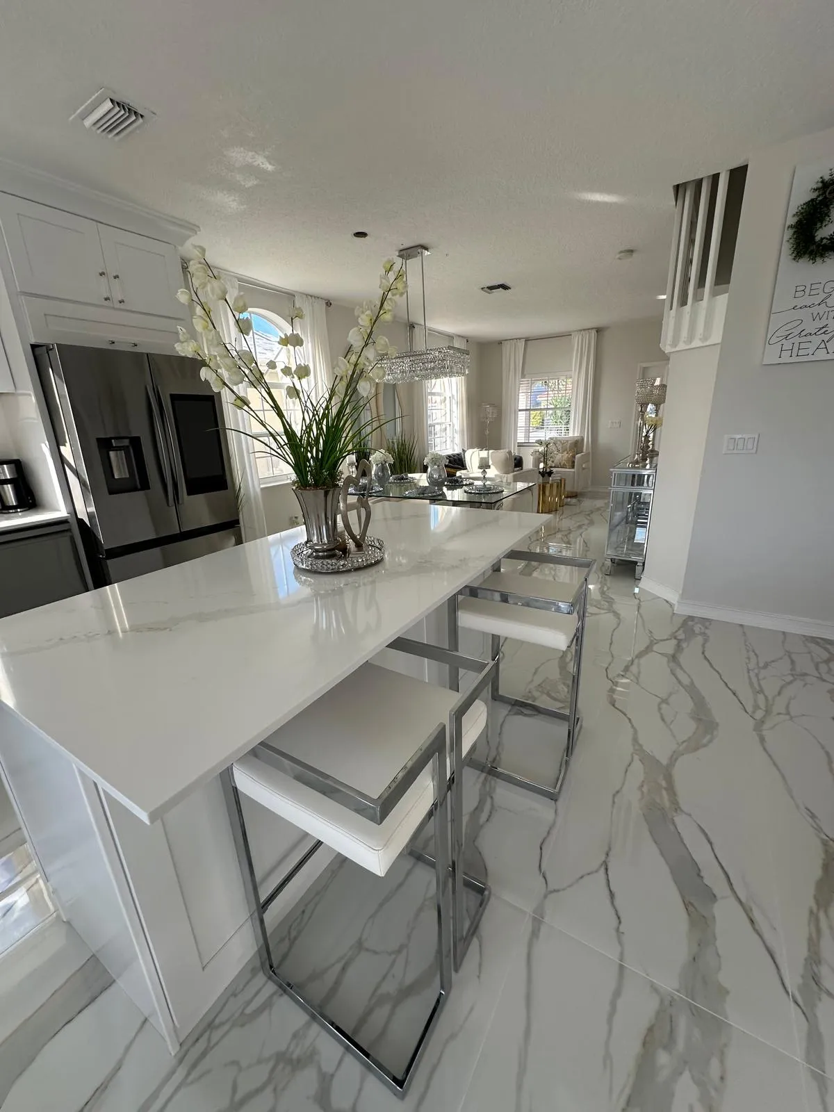 Kitchen island and marble-look tile floor finished by R&M Remodeling in Port St Lucie