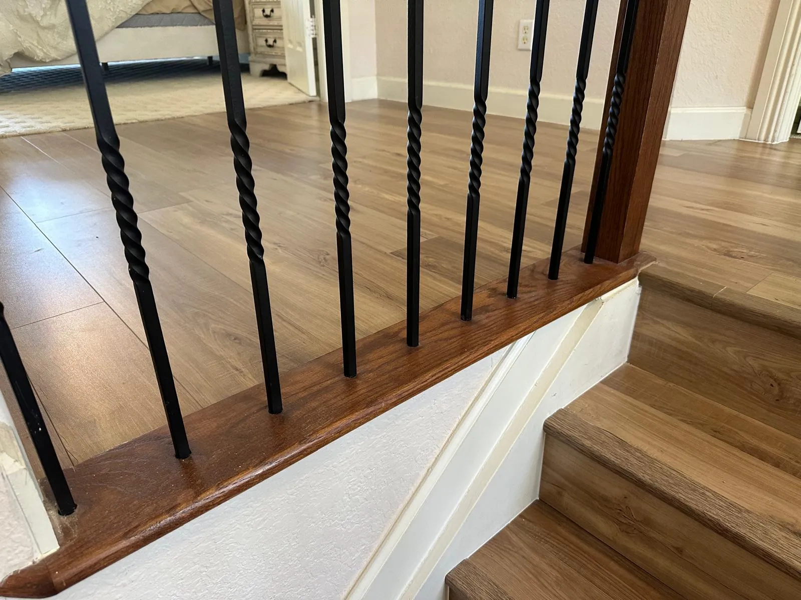 Stair railing and wood-look flooring finished by R&M Remodeling in Port St Lucie